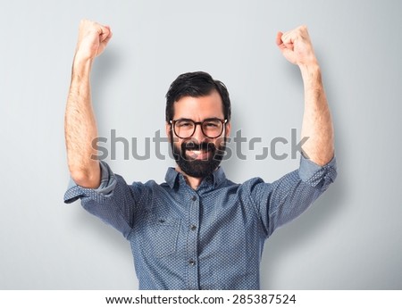 Lucky young hipster man over textured background