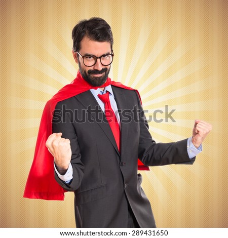 Lucky businessman dressed like superhero over pop background