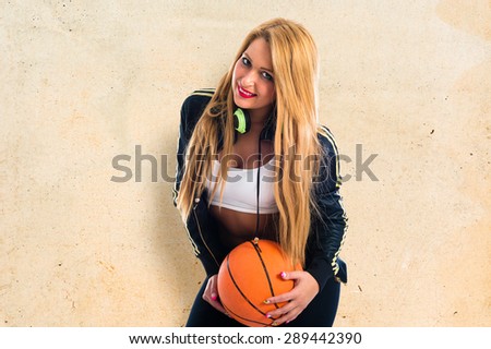 girl with a basketball over textured background