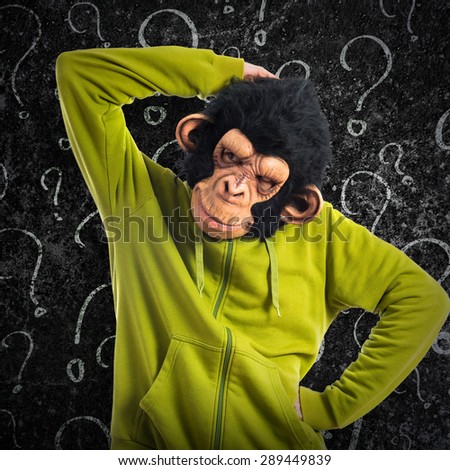 Monkey man thinking over textured background
