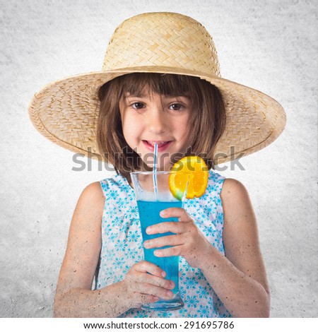 Girl drinking soda over grey background