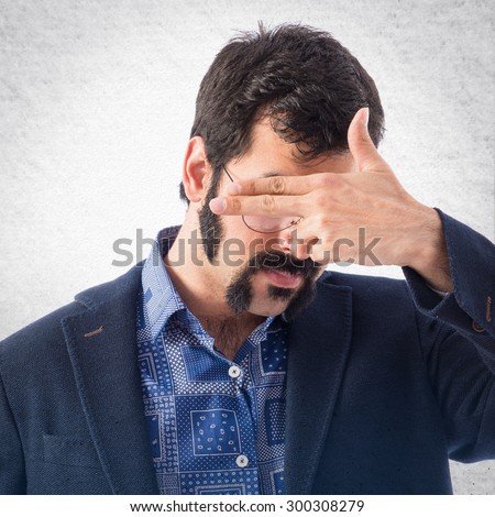 Vintage young man covering his eyes