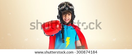 Girl dressed like superhero over ocher background