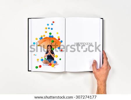 Girl holding an umbrella while raining colored balls printed on book