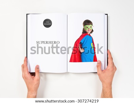 Girl dressed like superhero printed on book