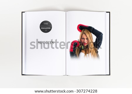 Sexy blonde girl with boxing gloves printed on book