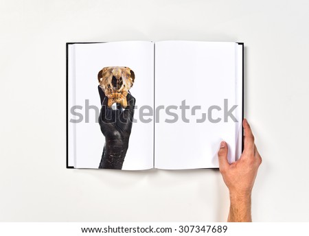 Primitive man holding rabbit skull printed on book