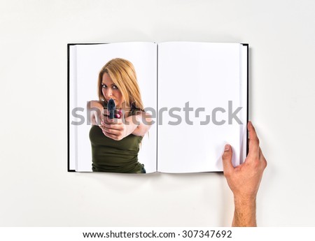 Military woman aiming a gun printed on book