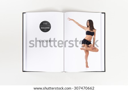 Pretty fitness female posing printed on book