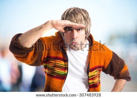 Blonde man showing something on unfocused background