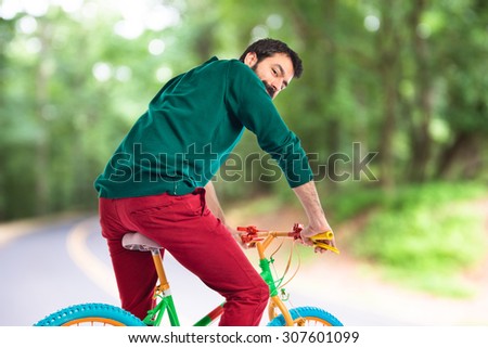 Man on bike on unfocused background