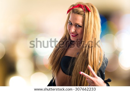 Sexy girl with motorbike jacket doing victory gesture