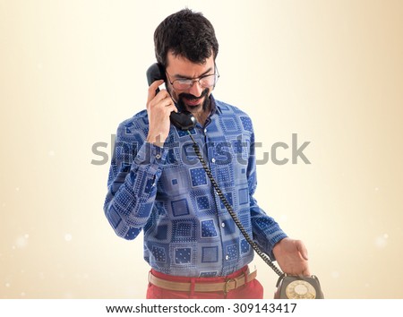 Vintage young man talking to vintage phone