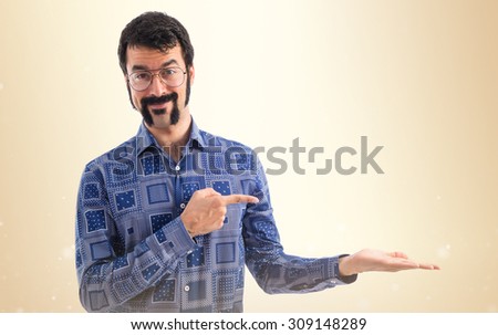 Vintage young man pointing and holding something