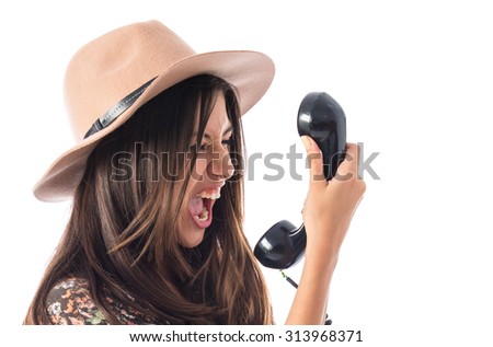 Angry woman talking to vintage phone