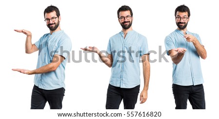 Similar – Image, Stock Photo Young man holding a small plant of cactus with his left hand. He’s in the center of the image. The background is yellow. The cactus is inside a brown vase