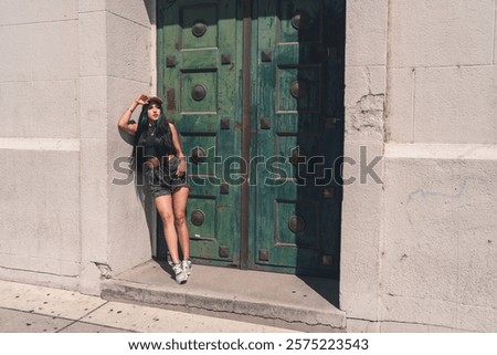 Similar – Image, Stock Photo Woman leaning against door in front of red wall