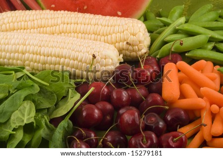 Fresh carrots,sugar snap peas, white corn,rhubarb, watermelon, baby spinach and cherries make up this healthy grouping of fruits and vegetables.