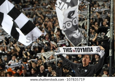THESSALONIKI, GREECE - MARCH 16: Fans and supporters of PAOK team in football match between Paok and AEK cheering for their team goals on March 16, 2011 in Thessaloniki, Greece.