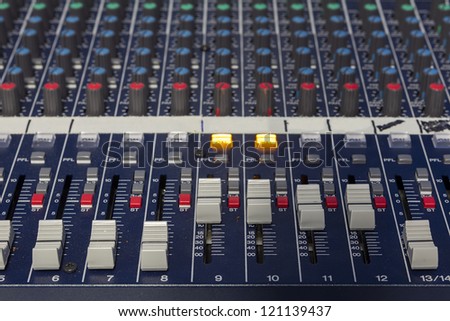 A mixing console, or audio mixer