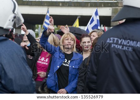 THESSALONIKI,GREECE-APR,14:Demonstrators shout slogans outside the police station during a protest against the arrest of residents for attacking a Canadian Eldorado Gold,in Thessaloniki,14 April 2013