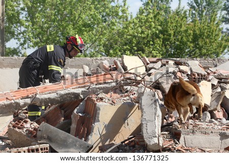 THESSALONIKI,GREECE - APRIL 19:Rescuer with rescue dog in ruins of buildings, During A training exercise for consequences earthquake in Industrial Area of Sindos,April 19,2013 in Thessaloniki,Greece