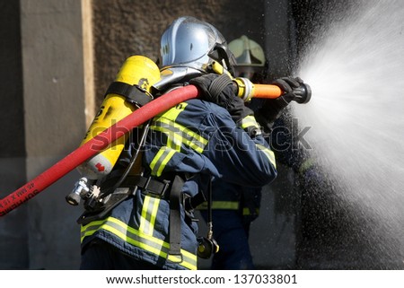 THESSALONIKI, GREECE - APRIL 19:Firefighter fighting for a fire attack, during a training exercise for the consequences earthquake in industrial area of Sindos on April 19,2013 in Thessaloniki, Greece