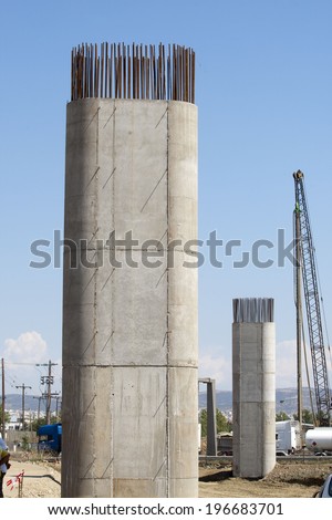 Pillar concrete under construction with reinforced steel rods or bars used to reinforce concrete.