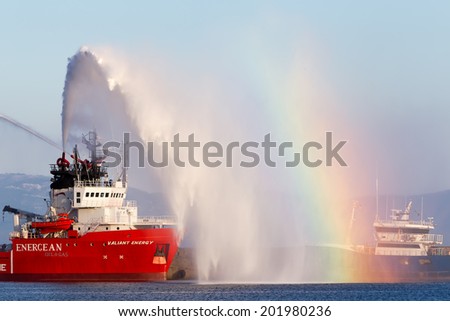 KAVALA, GREECE- JUNE 21, 2014: Valiant energy ship throws water during the opening ceremony for the exhibition for Kavala Airshow 2014, in Kavala, Greece.