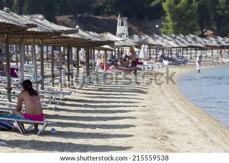 MARMARAS, GREECE- JULY 29, 2014: Tourists enjoying a nice summer day at the hotel Porto Carras beach of Marmaras in Chalkidiki, Greece. Porto Carras is the most outstanding family resort in Greece.