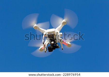 ATHENS, GREECE- OCTOBER 12, 2014: DJI Phantom drone in flight with a mounted GoPro Hero3+ Black Edition digital camera in Athens, Greece. DJI Industries produces unmanned aircraft for surveillance
