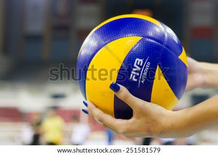 THESSALONIKI, GREECE - FEBRUARY 5, 2015 : Closeup of hands holding a volleyball ball during the Hellenic Volleyball League game Paok vs Aris at PAOK Sports Arena.