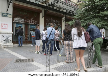 THESSALONIKI, GREECE,JUN 27 2015: People stand in a queue to use the ATMs of a bank. Greece's fraught bailout talks with its creditors took a dramatic turn, with the government announcing a referendum