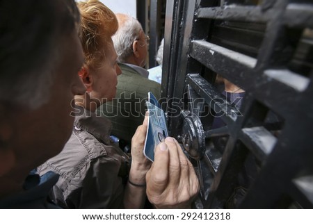 THESSALONIKI, GREECE, JULY, 1 2015: Pensioners queue outside a National Bank branch as banks only opened for the retired to allow them to cash up to 120 euros in Athens