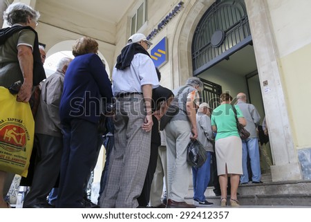 THESSALONIKI, GREECE, JULY, 1 2015: Pensioners queue outside a National Bank branch as banks only opened for the retired to allow them to cash up to 120 euros in Athens