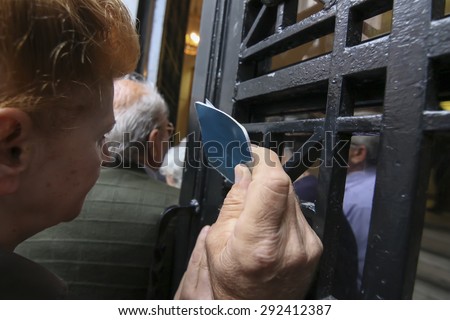 THESSALONIKI, GREECE, JULY, 1 2015: Pensioners queue outside a National Bank branch as banks only opened for the retired to allow them to cash up to 120 euros in Athens