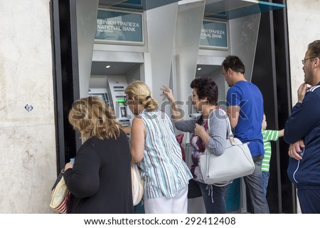 THESSALONIKI, GREECE,JULY 1 2015: People stand in a queue to use the ATMs of a bank. Greece\'s fraught bailout talks with its creditors took a dramatic turn, with the government announcing a referendum