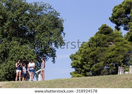 Olympia, Greece- August 9, 2015: Tourists at Olympia, birthplace of the Olympic games, in Greece.