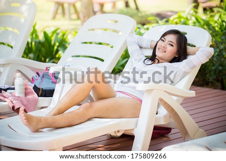 Asians  beautiful women lying poolside in a bikini