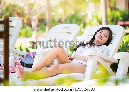Asians  beautiful women lying poolside in a bikini