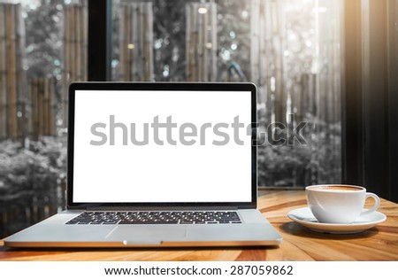 laptop for blank and coffee on a table showing break or breakfast in coffee shop or office,late art