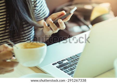 Close up of hands woman using her cell phone in coffee shop,cafe