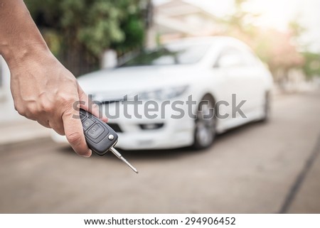 hand presses on the remote control car alarm systems
