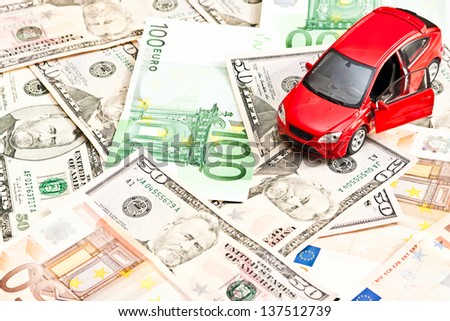 Toy car and money over white. Rent, buy or insurance car concept