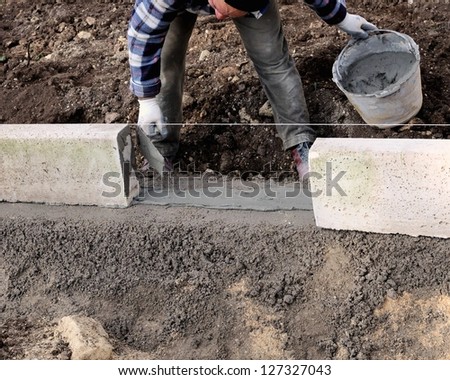 Construction site - Workers laying concrete curbs