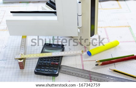 Studies node vertical aluminium frame box with calculator, pens, pencils, and decimeter on a desktop