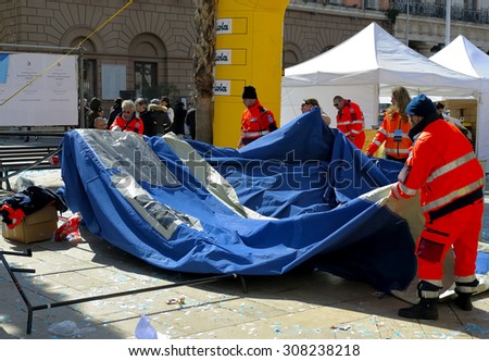 BARI, ITALY - March 8, 2015: Volunteers of the Civil Protection dismantled a tent during the Deejay Ten Bari organized by Linus and Radio Deejay.