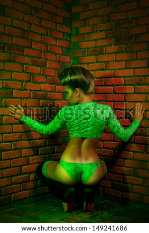 Backside photo of nice adult woman bear brick wall