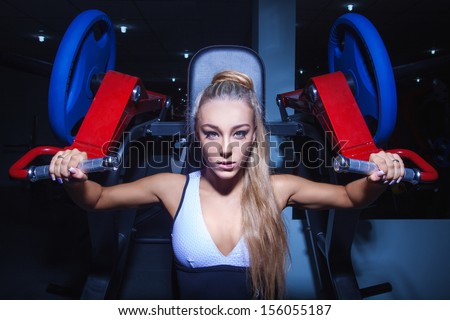 workout on body builder of athletic woman at gym