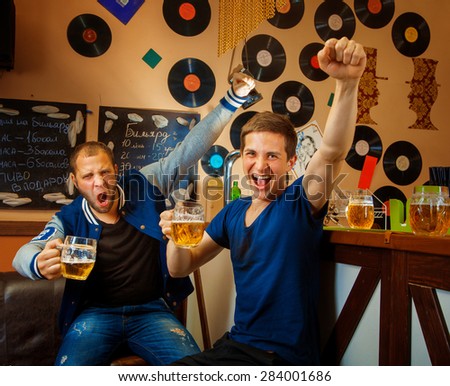 two friends drink beer in bar and have fun. square photo